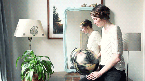 Animated-gif-of-woman-spinning-an-Earth-globe